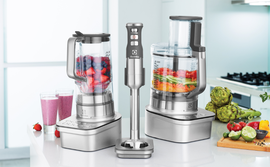 "A digital photograph showcasing smart kitchen gadgets including an automatic stirrer, a digital measuring cup, and a multipurpose electric opener, arranged on a modern kitchen counter to highlight innovation and practicality."